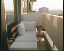 Balcony lounge with outdoor seating at Room Key Studios